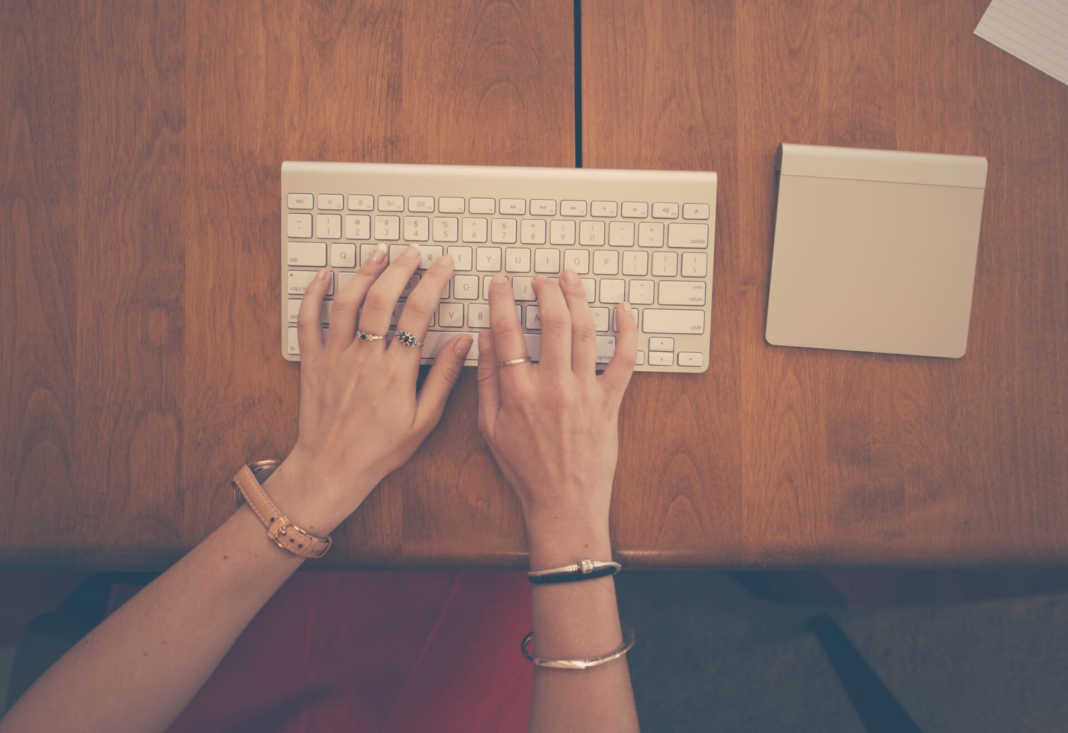 hands woman apple desk 1