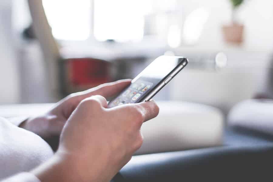 home office woman-using-her-iphone-at-home-office