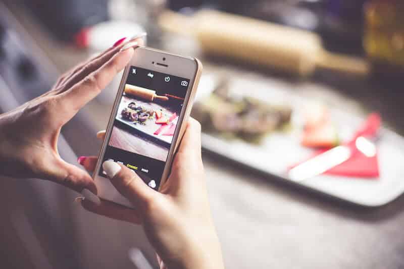 girl taking a photo of her food with iphone picjumbo com 1