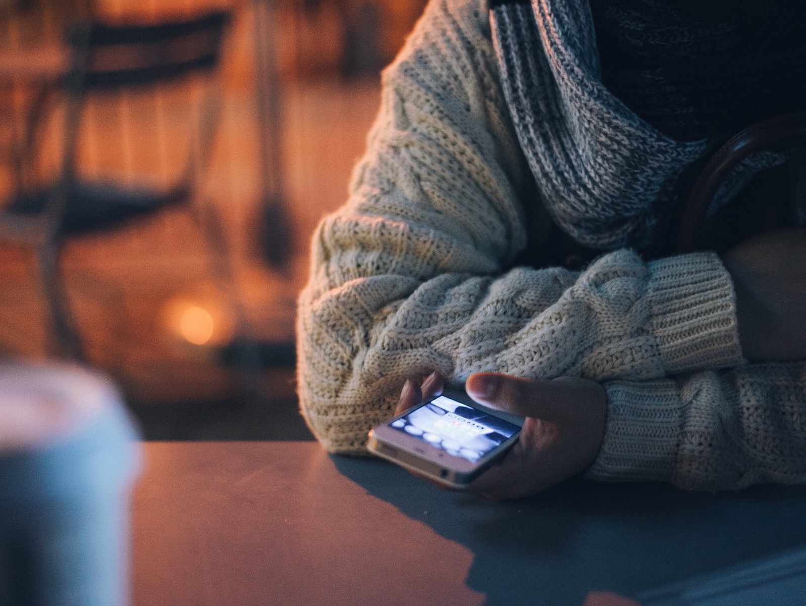 Pessoa com o telemóvel a fazer scroll nas redes sociais - Como viver sem Facebook e Instagram? - Nomadismo Digital Portugal